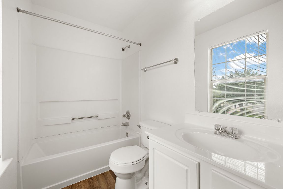 13718 Merseyside Drive Pflugerville, TX 78660 - Photo 11 of 13 a bathroom with a granite countertop sink toilet and shower