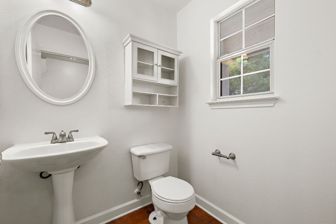 13718 Merseyside Drive Pflugerville, TX 78660 - Photo 4 of 13 a bathroom with a toilet sink and mirror