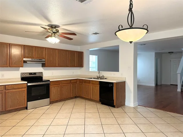 a kitchen with stainless steel appliances granite countertop a sink and stove top oven