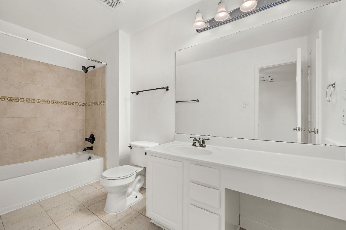 13718 Merseyside Drive Pflugerville, TX 78660 - Photo 8 of 13 a bathroom with a sink a toilet and a bathtub