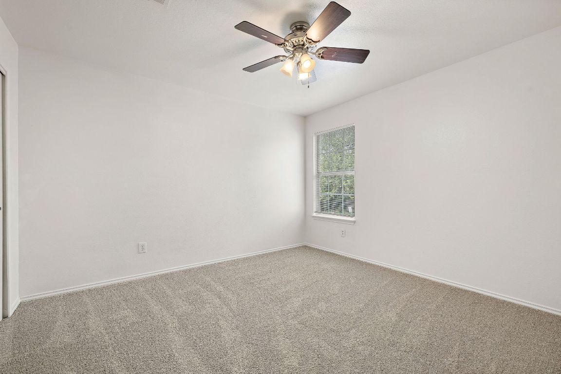 13718 Merseyside Drive Pflugerville, TX 78660 - Photo 9 of 13 an empty room with a window and a fan