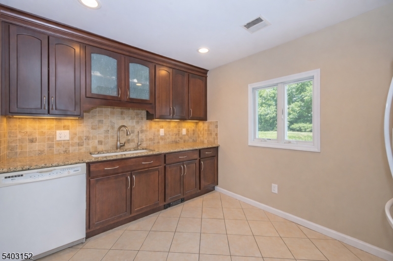 2 Robert Street Flanders, NJ 07836 - Photo 13 of 38 a kitchen with granite countertop a sink window and cabinets