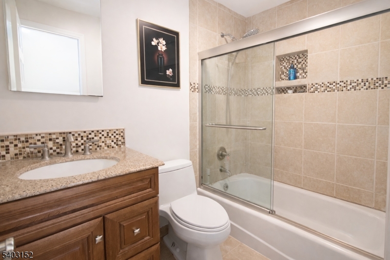 2 Robert Street Flanders, NJ 07836 - Photo 15 of 38 a bathroom with a granite countertop sink a toilet and shower