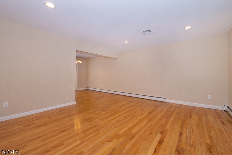 2 Robert Street Flanders, NJ 07836 - Photo 9 of 38 a view of an empty room with wooden floor and fan