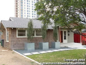 a view of a house with a patio and a yard