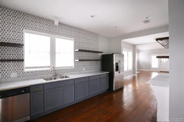 a kitchen with a sink window and cabinets