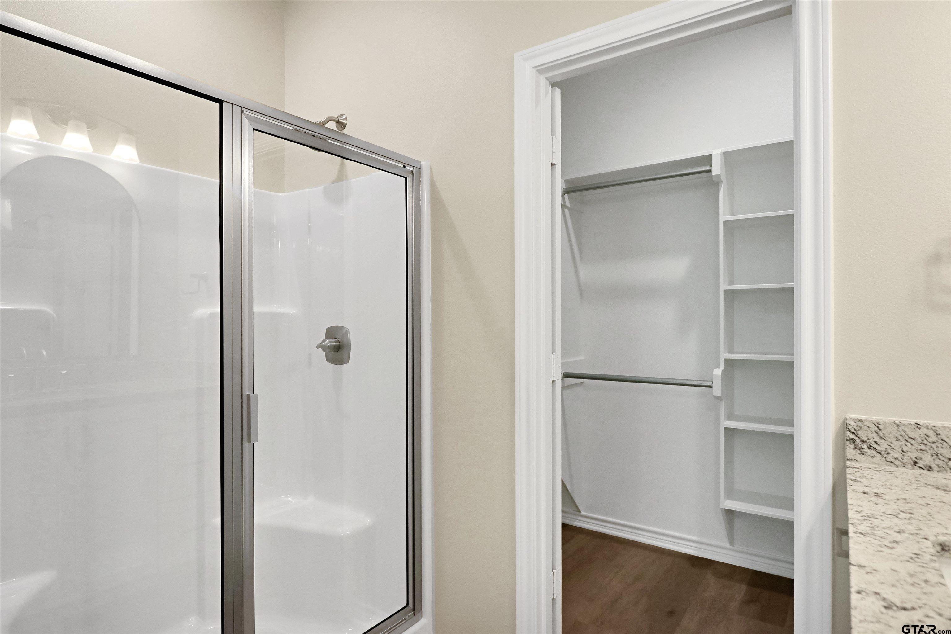 3053 Guinn Farms Road Tyler, TX 75707 - Photo 20 of 32 a bathroom with a glass shower door
