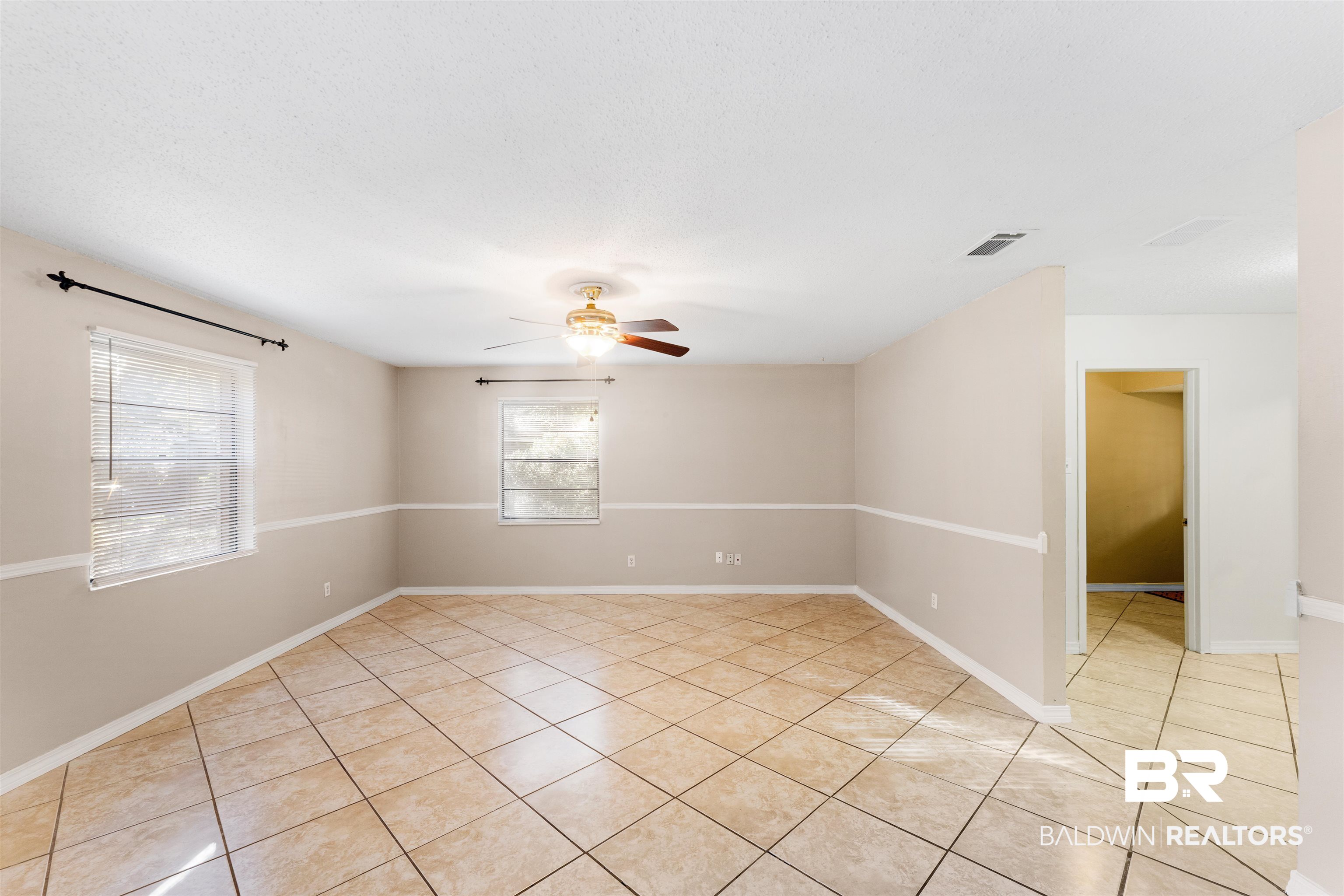 5551 Springer Court Theodore, AL 36582 - Photo 18 of 37 Spare room with light tile patterned flooring and ceiling fan