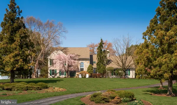 a kitchen with stainless steel appliances granite countertop a stove top oven a sink a dining table and chairs