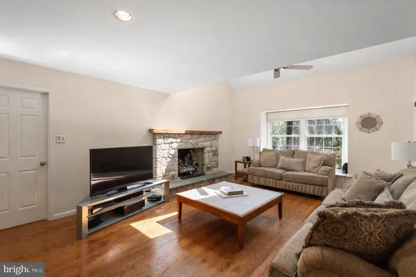 a dining hall with stainless steel appliances granite countertop a stove a sink a dining table and chairs