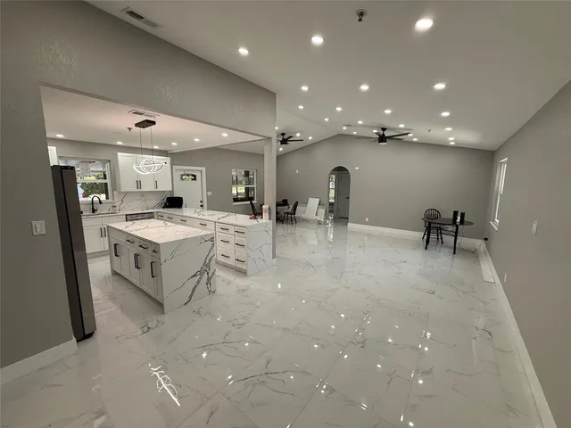 a large room with lot of table and chairs