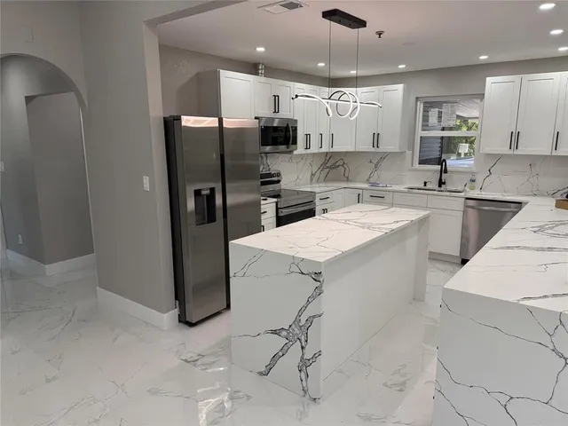 a kitchen with a refrigerator a sink and a stove