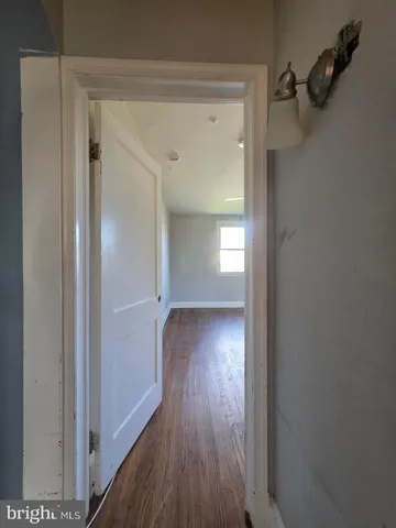 a view of a room with wooden floor closet and windows