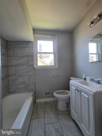 a bathroom with a sink a toilet and bathtub