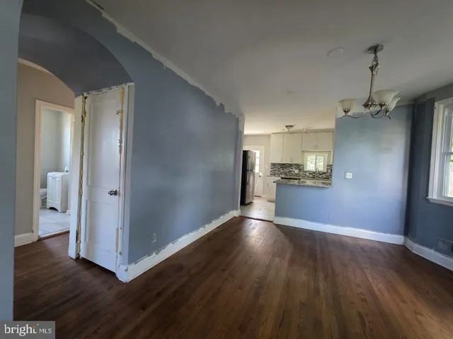 a view of a kitchen with wooden floor and a kitchen