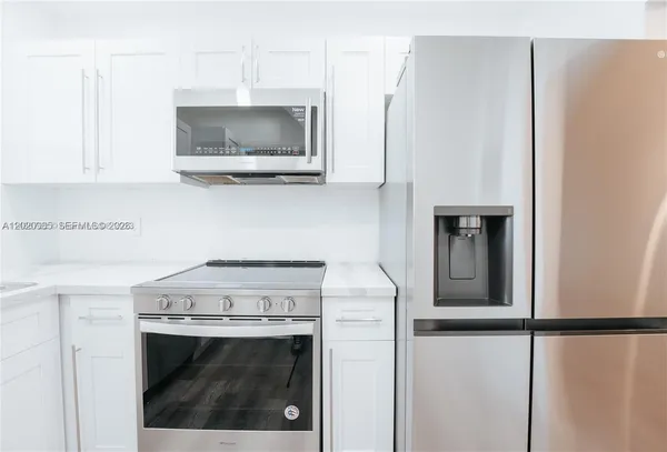 a kitchen with a stove and a microwave