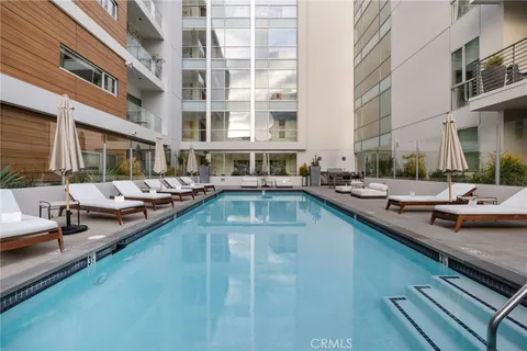 a spacious bedroom with a bed a table and chairs