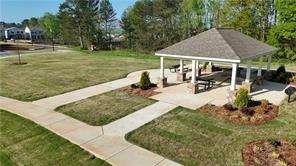 132 Galilee Lane Bethlehem, GA 30620 - Photo 13 of 13 a view of a patio with table and chairs under an umbrella
