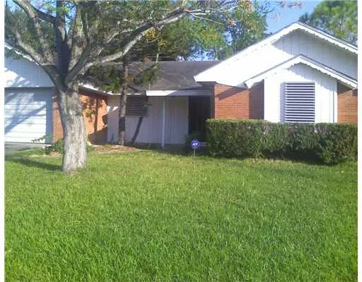 a view of a house with yard and a tree