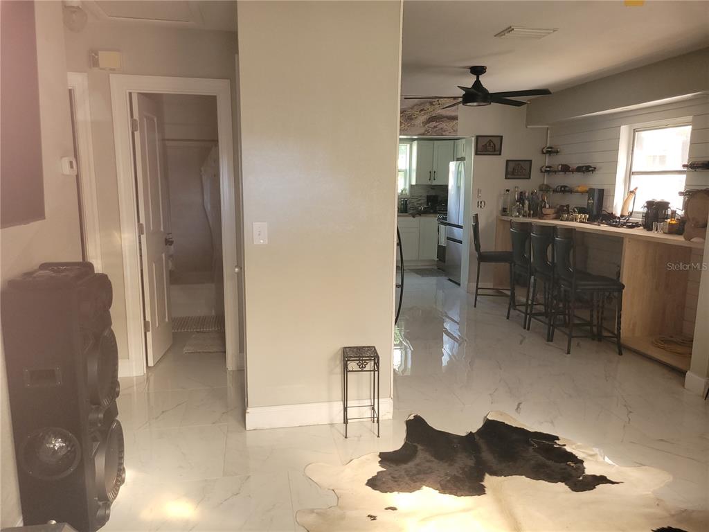 821 South Honey Way Inverness, FL 34450 - Photo 11 of 38 a kitchen with stainless steel appliances kitchen island granite countertop a refrigerator and a sink