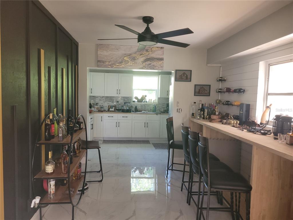 821 South Honey Way Inverness, FL 34450 - Photo 18 of 38 a kitchen with a table chairs refrigerator and cabinets