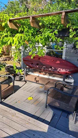 a balcony view with a couple of chairs and a potted plant