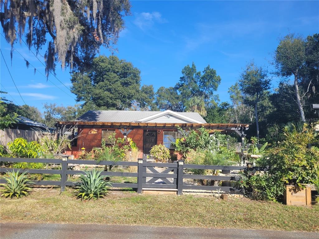 821 South Honey Way Inverness, FL 34450 - Photo 5 of 38 a view of a house with a yard and garden