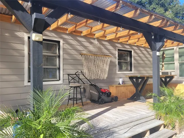 a view of a house with backyard and sitting area