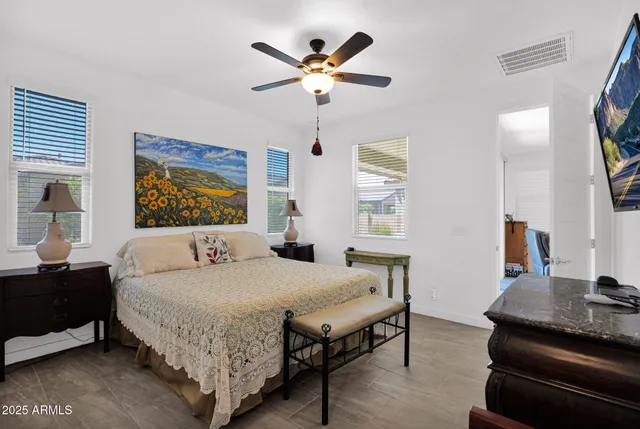 a bedroom with a large bed and a chandelier