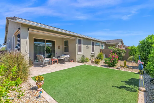 a view of a house with backyard porch and sitting area