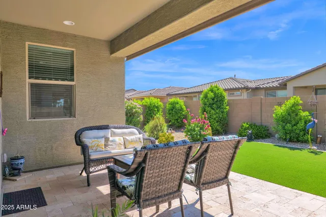 a view of a patio with a table chairs and a backyard