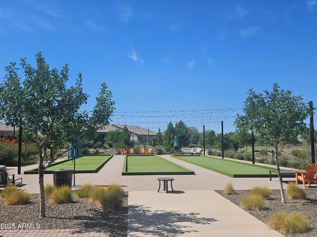 a view of a swimming pool with a yard and sitting area