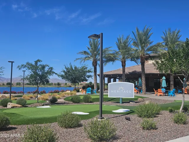 a front view of a house with garden and trees