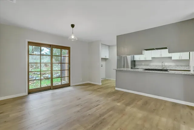 a kitchen with granite countertop cabinets a sink and a stove
