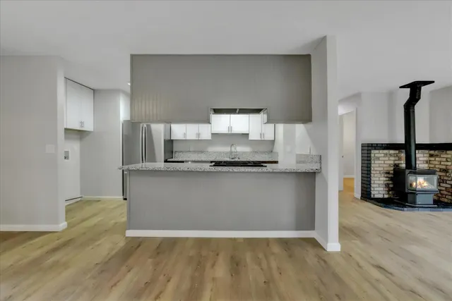 a kitchen with stainless steel appliances granite countertop a stove and a microwave
