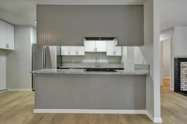 a kitchen with stainless steel appliances granite countertop a refrigerator sink and cabinets