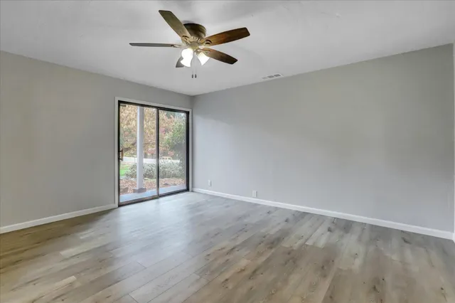 wooden floor in an empty room with a window
