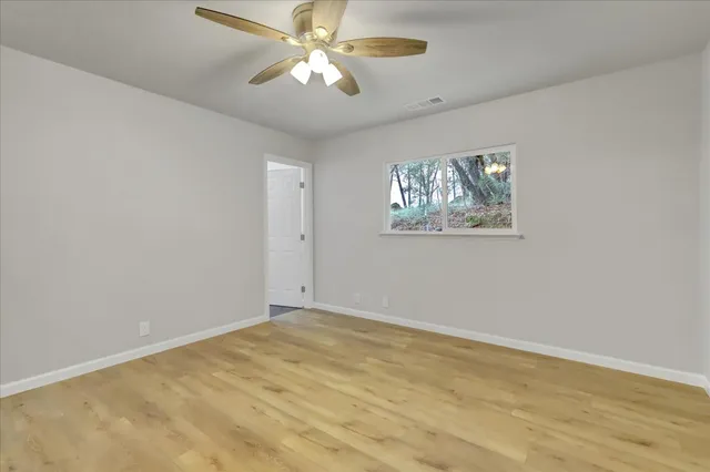 an aerial view of a houses with a lush green hillside