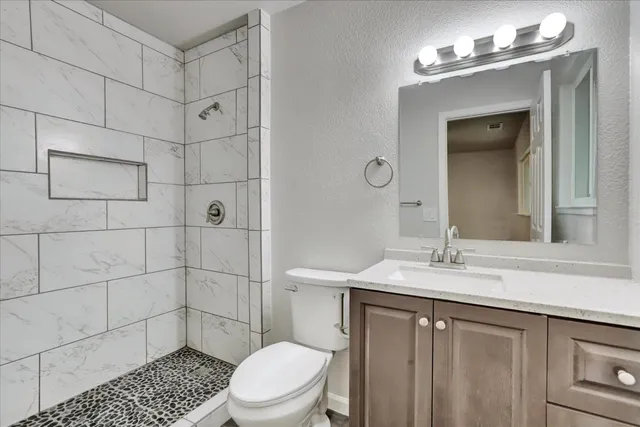 a backyard of a house with a garden and outdoor seating