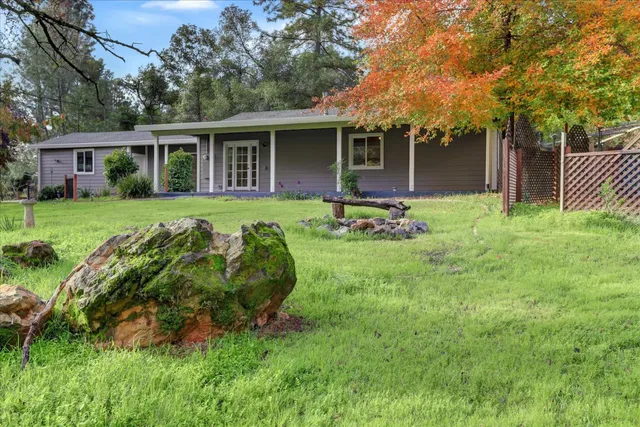 an aerial view of residential houses with outdoor space and street view