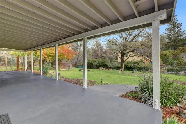 a view of residential houses with outdoor space and trees