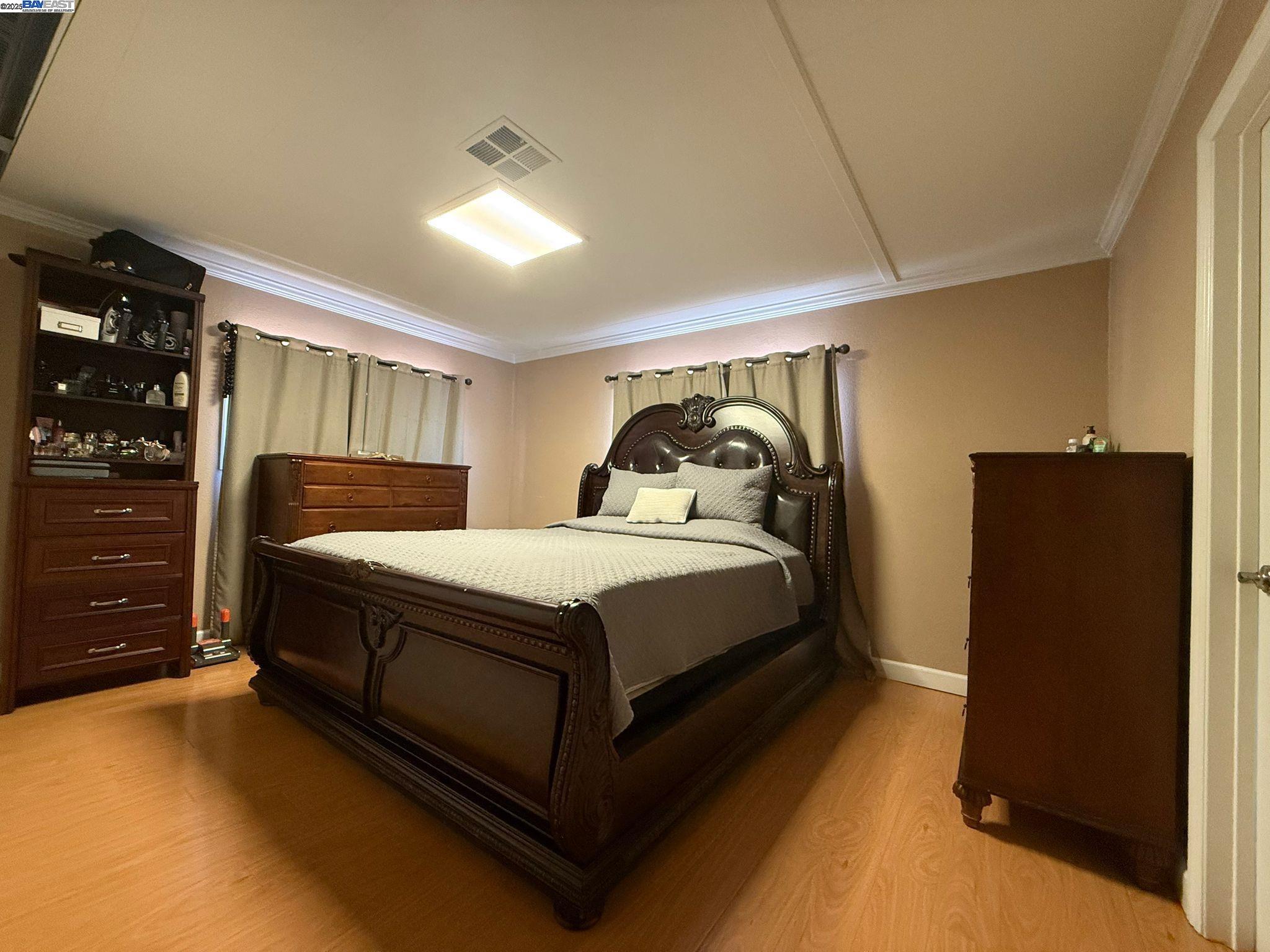 28290 Applegate Street Hayward, CA 94545 - Photo 7 of 20 a bedroom with a bed and cabinet