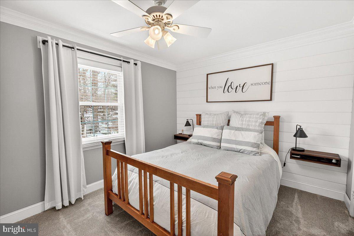 24013 Bush Hill Road Gaithersburg, MD 20882 - Photo 16 of 38 a bed sitting in a bedroom next to a window