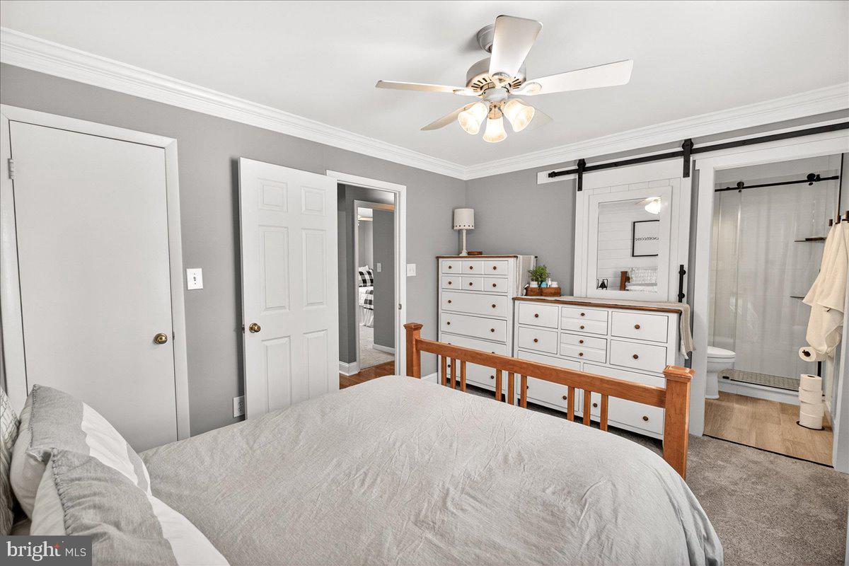 24013 Bush Hill Road Gaithersburg, MD 20882 - Photo 17 of 38 a bedroom with a bed a chandelier and a chandelier