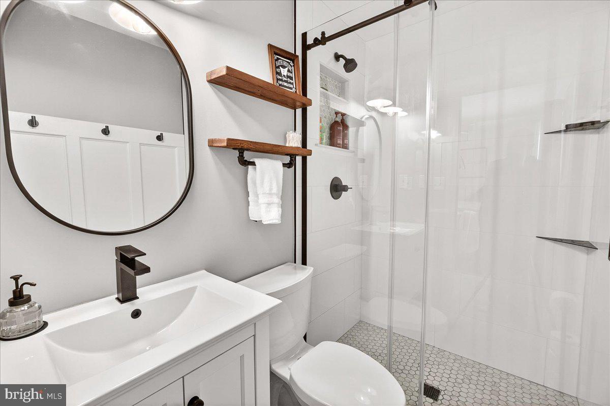 24013 Bush Hill Road Gaithersburg, MD 20882 - Photo 18 of 38 a bathroom with a sink toilet and shower