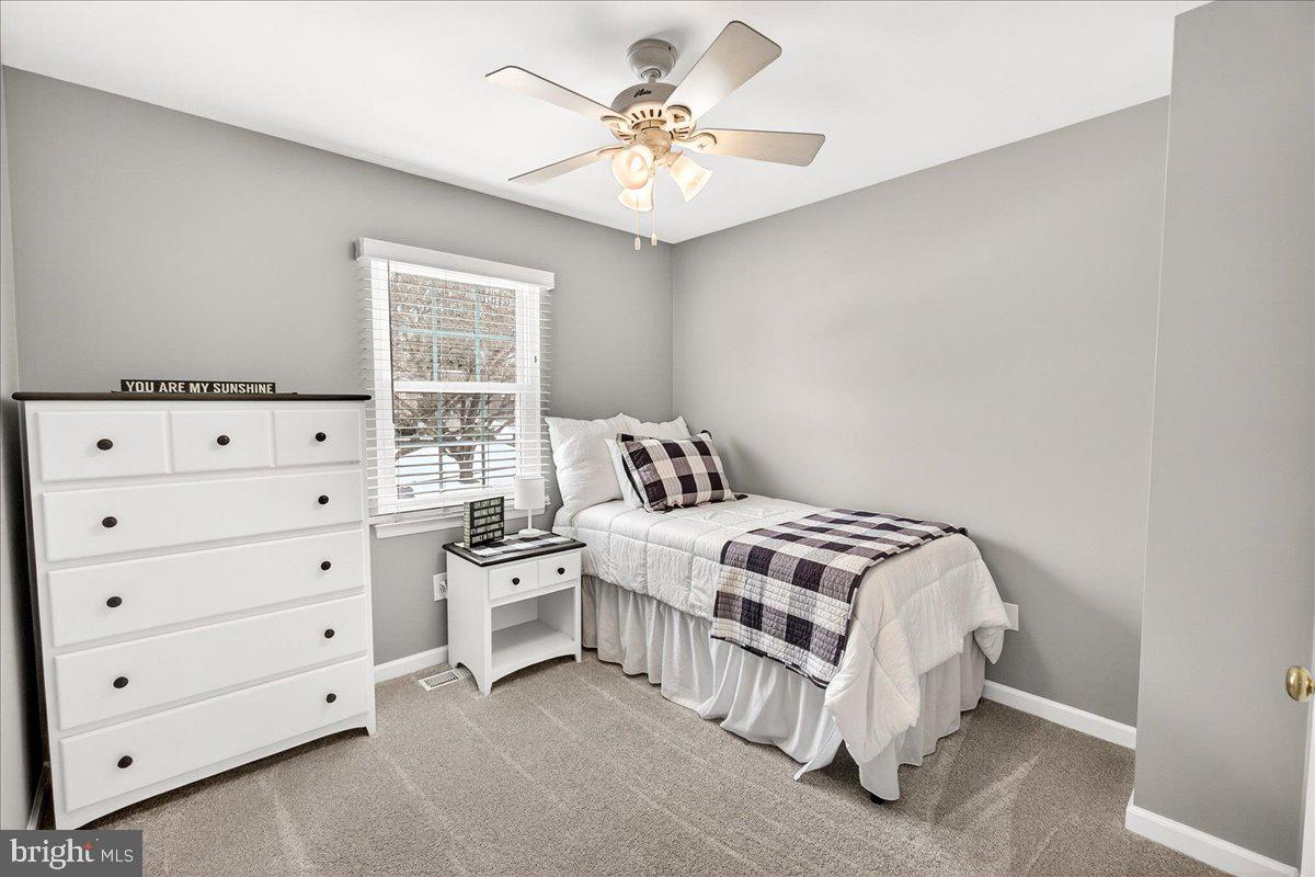 24013 Bush Hill Road Gaithersburg, MD 20882 - Photo 19 of 38 a bedroom with a bed and a chandelier