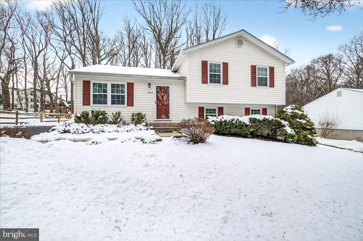 24013 Bush Hill Road Gaithersburg, MD 20882 - Photo 2 of 38 a front view of a house with a yard covered in snow
