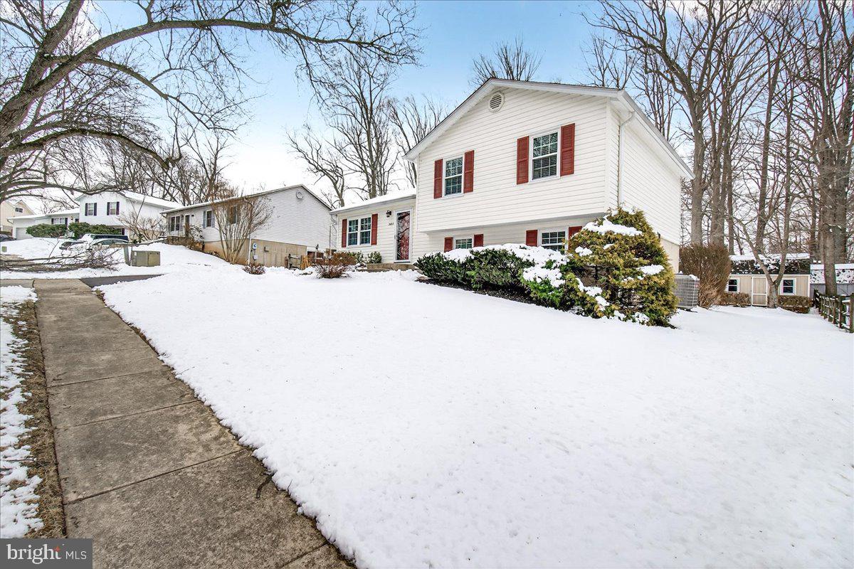 24013 Bush Hill Road Gaithersburg, MD 20882 - Photo 3 of 38 a front view of a house with a yard and garage