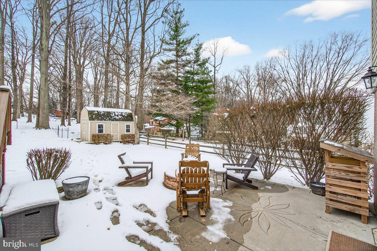 24013 Bush Hill Road Gaithersburg, MD 20882 - Photo 31 of 38 a outdoor space with patio couches and a potted plant on a table and chairs