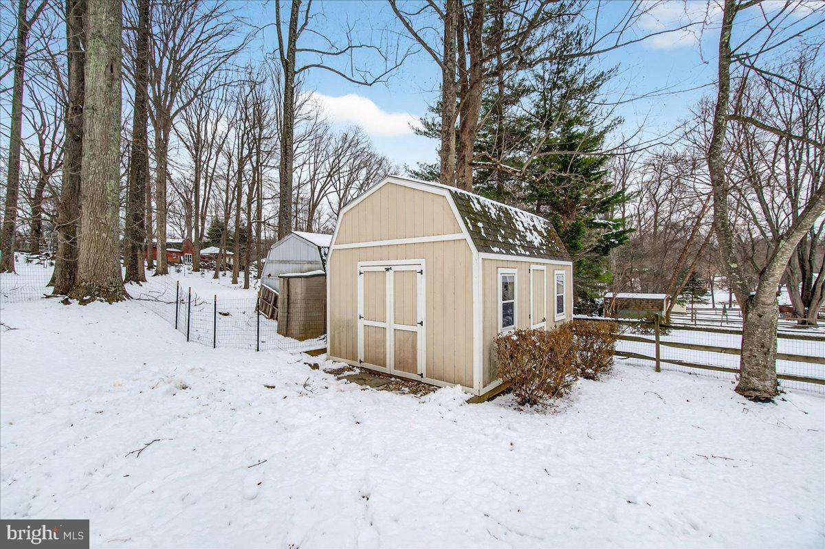 24013 Bush Hill Road Gaithersburg, MD 20882 - Photo 32 of 38 a view of a house with a yard covered in snow